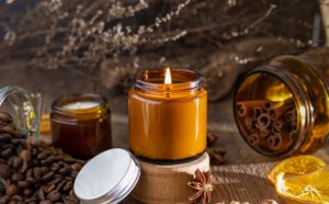 Aroma candle in a brown glass jar. Burning scented candles. Smell and smoke. Aromatherapy