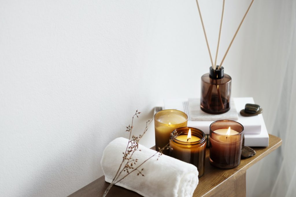 Aromatherapy table setting with scented candles and towel